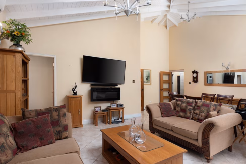 Charming 7-bed home in Christ Church with two 3-bed apartments & studio flat. Spacious, furnished, income potential, near shops & the airport.